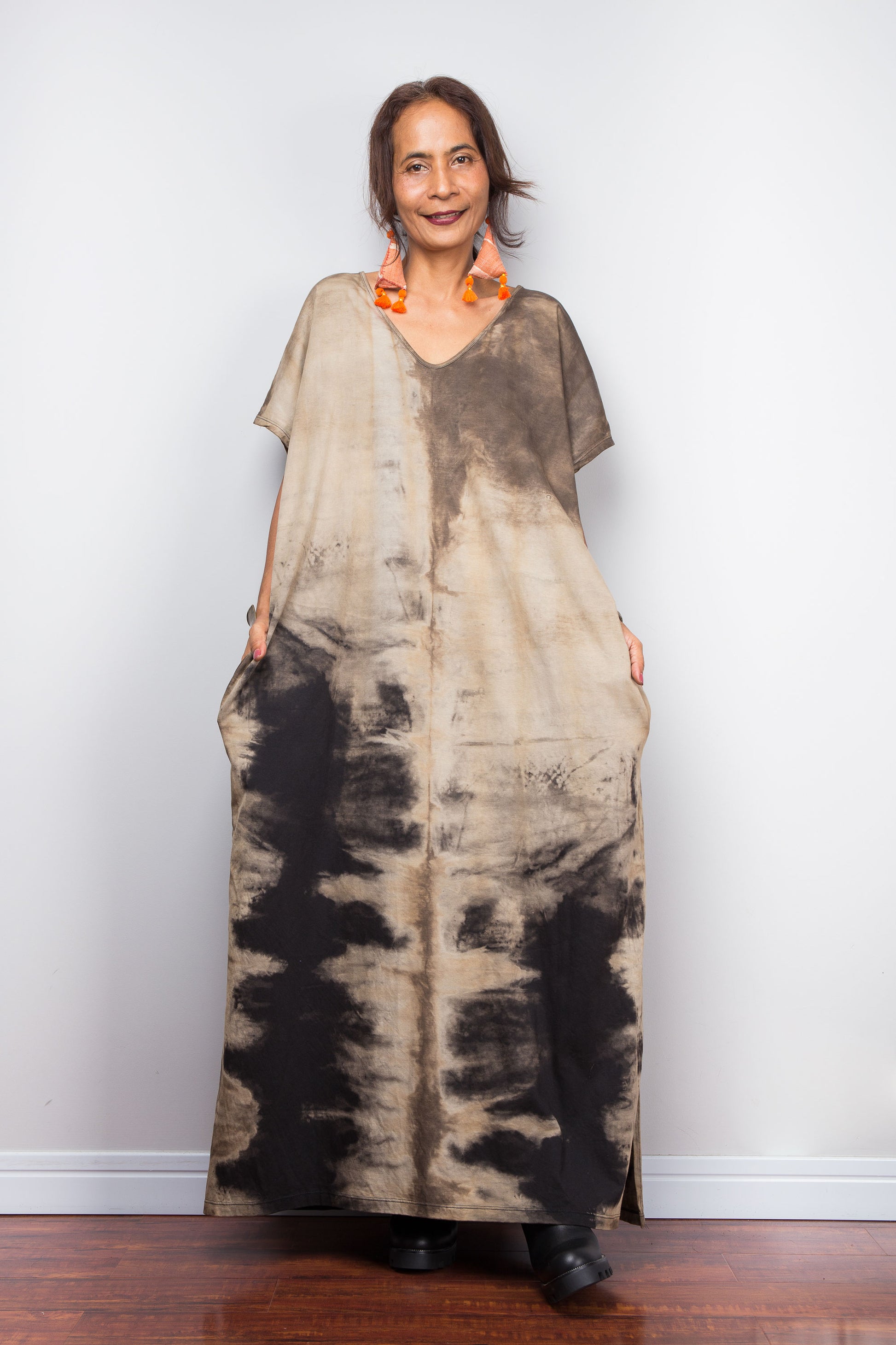 Front view of a petite woman styling Nuichan's oversized reverse tie-dye kaftan dress, showcasing the loose fit and sand-colored pattern.