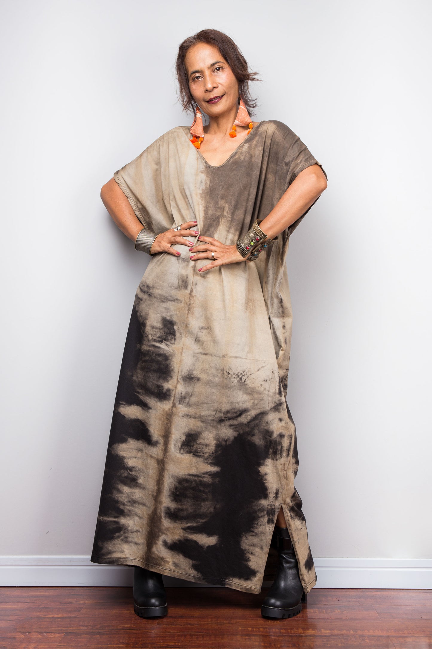 Front view of a petite model styling Nuichan's oversized reverse tie-dye kaftan dress, soft round v-neck, showcasing the loose fit and sand-colored pattern.