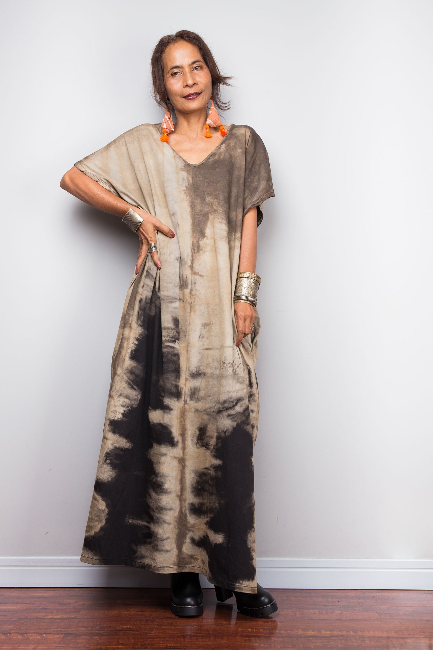 Front view of a model styling Nuichan's oversized reverse tie dye dress, showcasing the loose fit and sand-colored pattern.