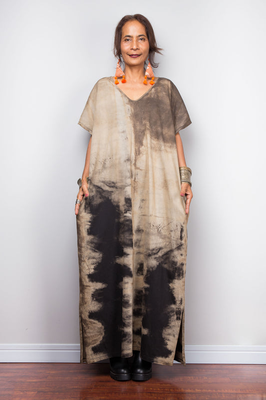 Front view of a model styling Nuichan's oversized reverse tie-dye kaftan dress, showcasing the loose fit and sand-colored pattern.