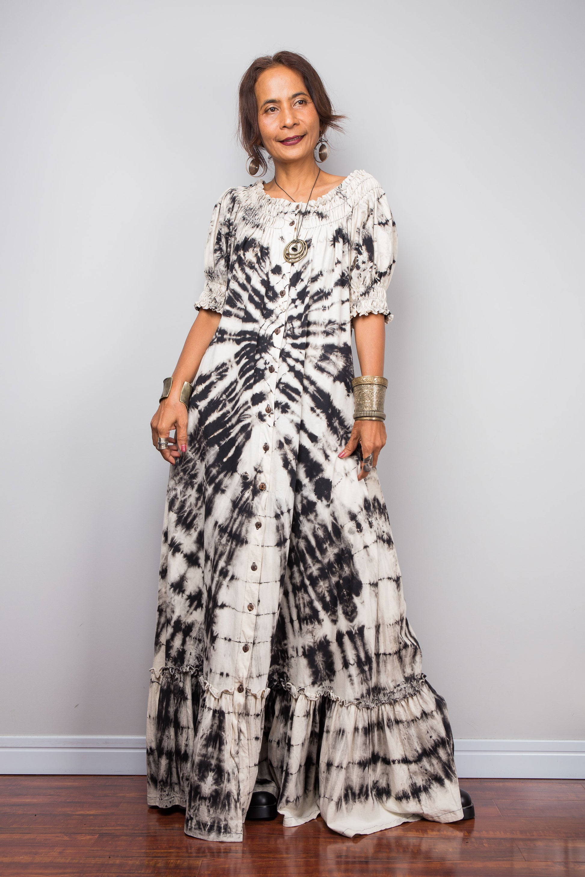 Front view of a Model wearing the Nuichan bohemian long shirt dress with the smocked neckline styled as a scoop neck, emphasizing the functional front buttons and side pockets.