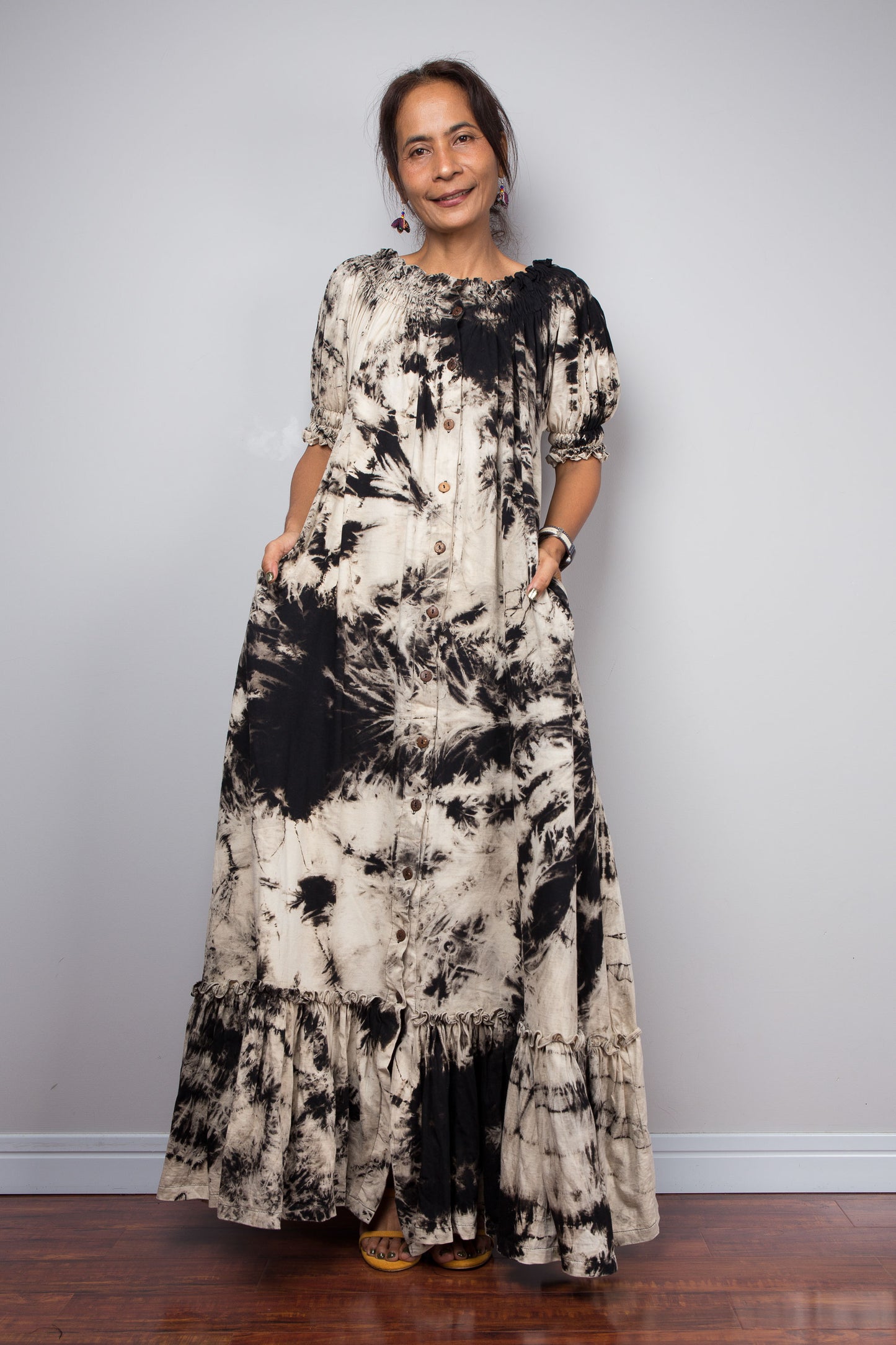 Full-length view of a model wearing the Nuichan reverse tie dye maxi shirt dress with the smocked neckline styled as a classic gathered scoop neck, showing the versatile two-way neckline and tiered ruffle hem
