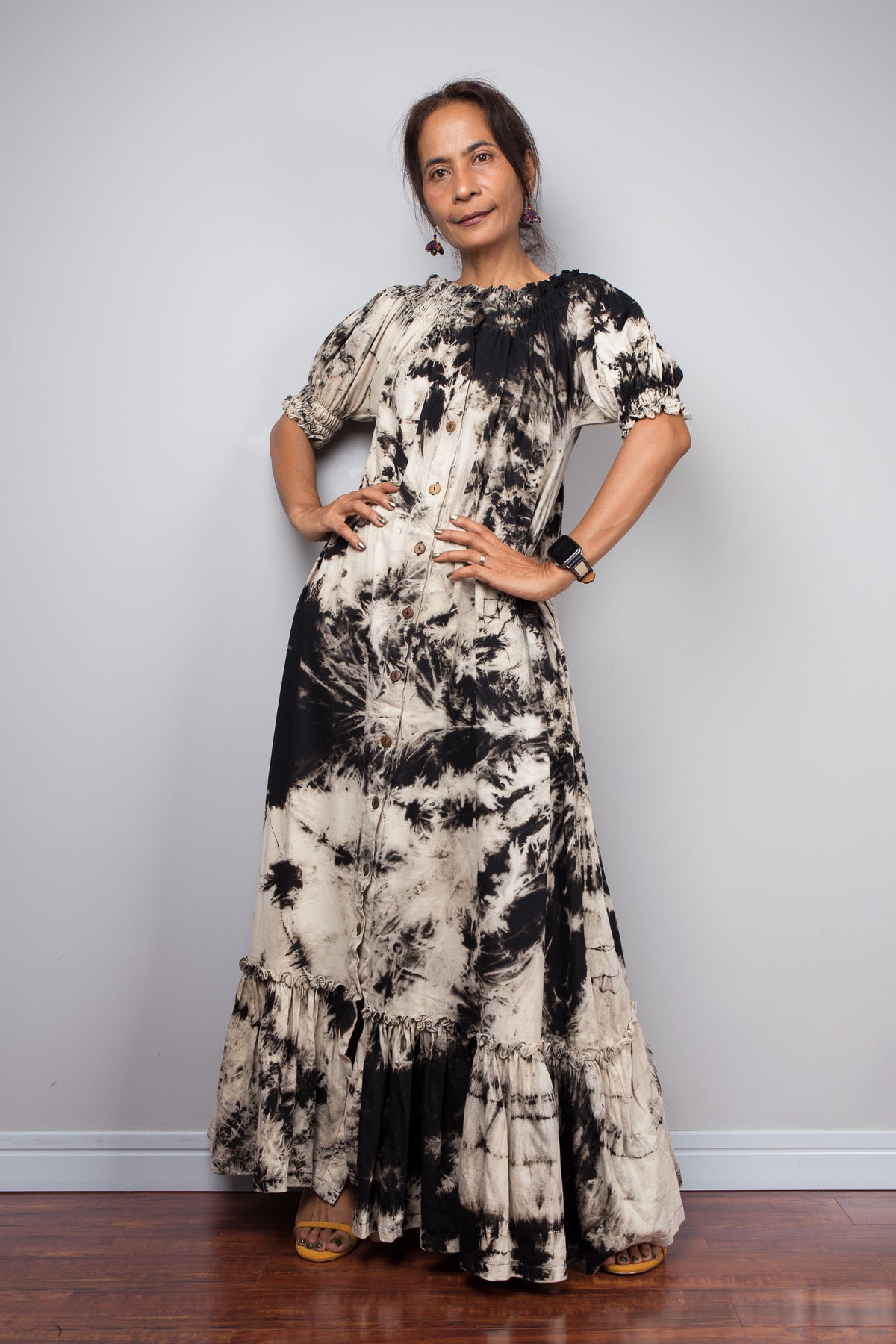Full-length front view of a model wearing the Nuichan reverse tie dye maxi shirt dress with the smocked neckline styled as a classic gathered scoop neck, showing the versatile two-way neckline and tiered ruffle hem