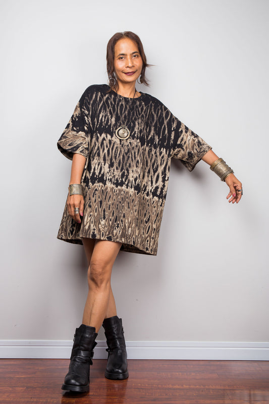 Front view of a model styling Nuichan's oversized reverse tie-dye t-shirt, showcasing the loose boxy fit and black with sand-colored pattern.