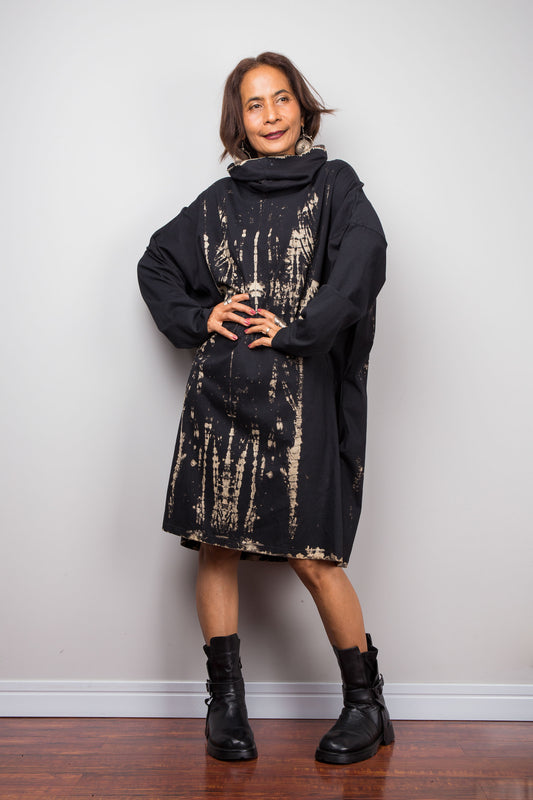 Oversized Nuichan reverse tie dye tunic dress featuring a cowl neck and vertical abstract sand and black patterns.