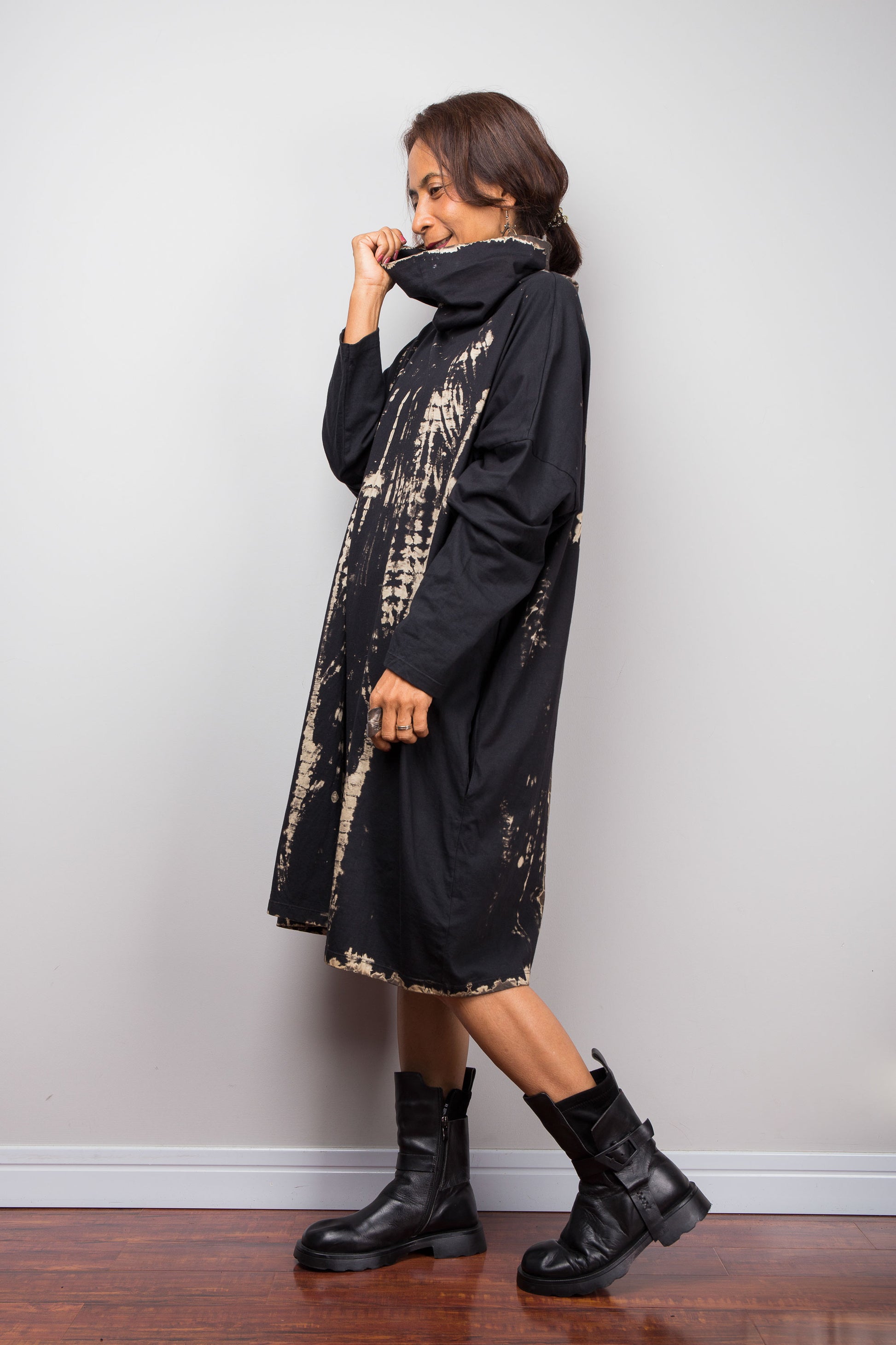 Oversized Nuichan reverse tie dye tunic dress featuring a cowl neck and vertical abstract sand and black patterns.  Side view showing the funnel neck.