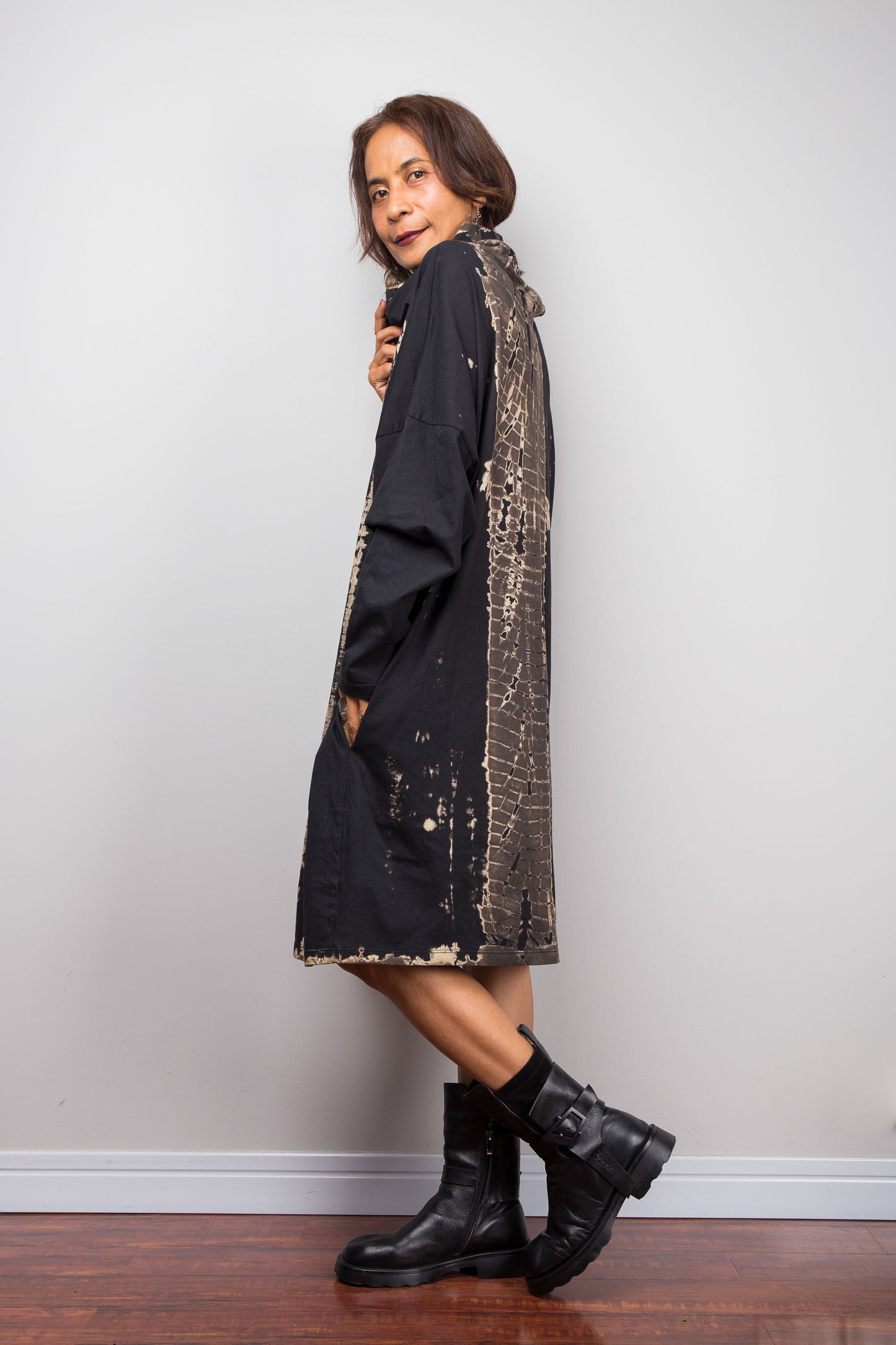 Oversized Nuichan reverse tie dye tunic dress featuring a cowl neck and vertical abstract sand and black patterns.  Side on view