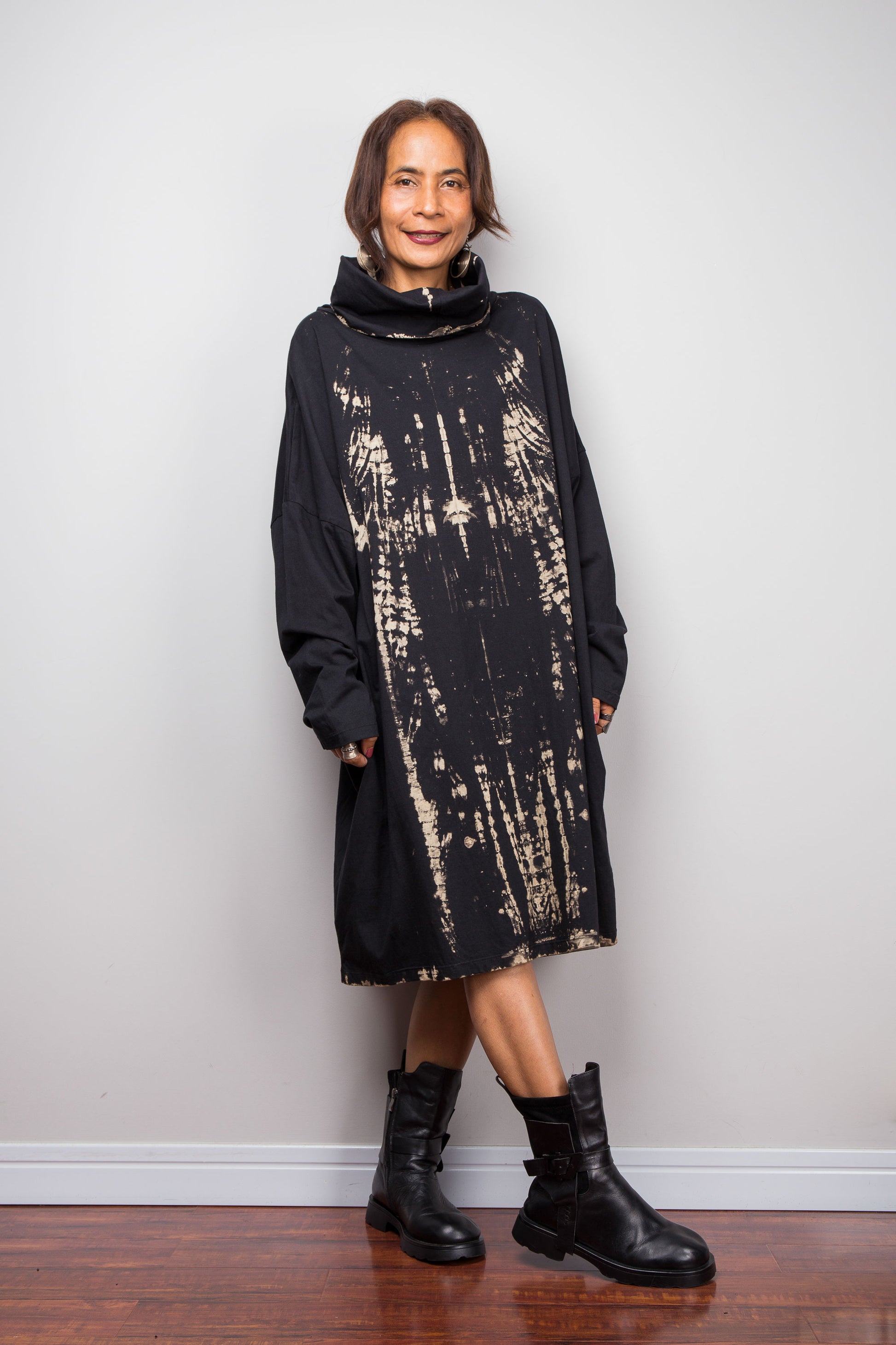 Oversized Nuichan reverse tie dye tunic dress featuring a cowl neck and vertical abstract sand and black patterns.  Front view showing the long sleeves and mid length of the tunic