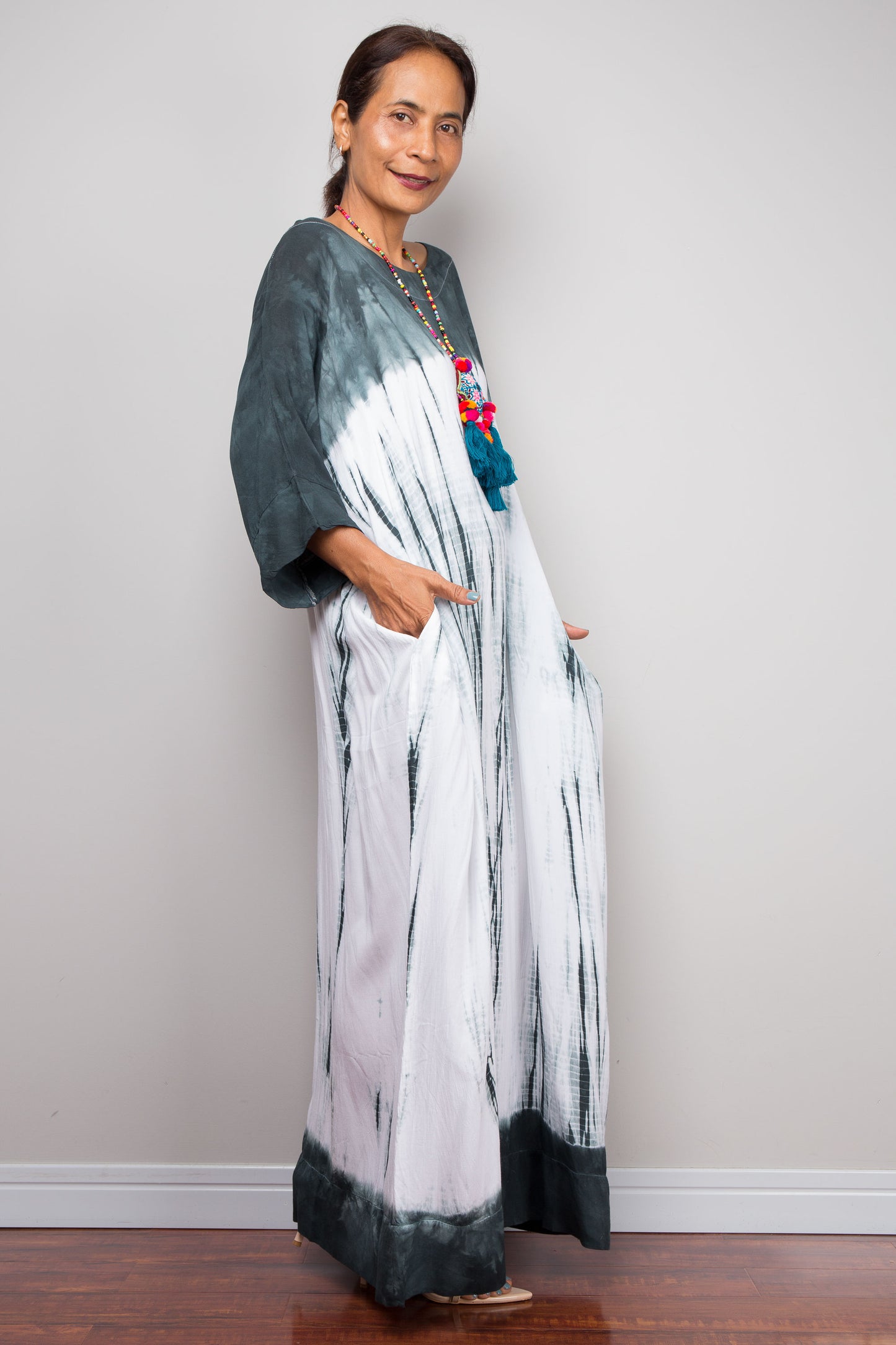 Side full-length view of the relaxed fit rayon spandex Shibori tie-dye summer dress by Nuichan, displaying its fluid drape and classic boat neckline.