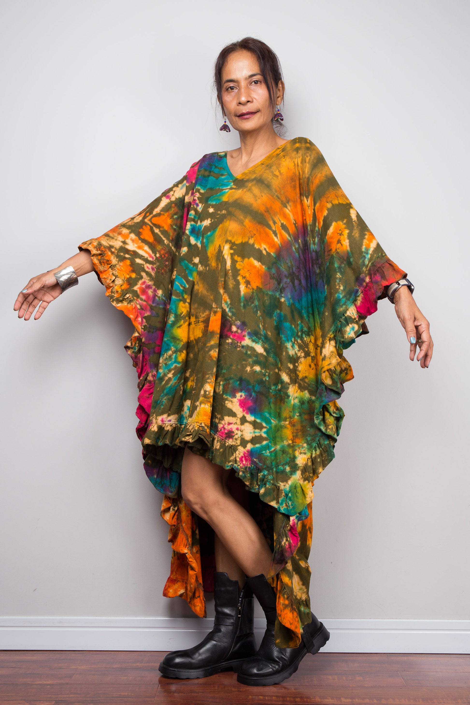 Petite Woman wearing a colorful, tie dye kaftan tunic dress against a plain background