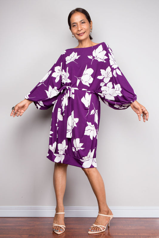 Petite Woman wearing a purple floral tunic dress against a plain background