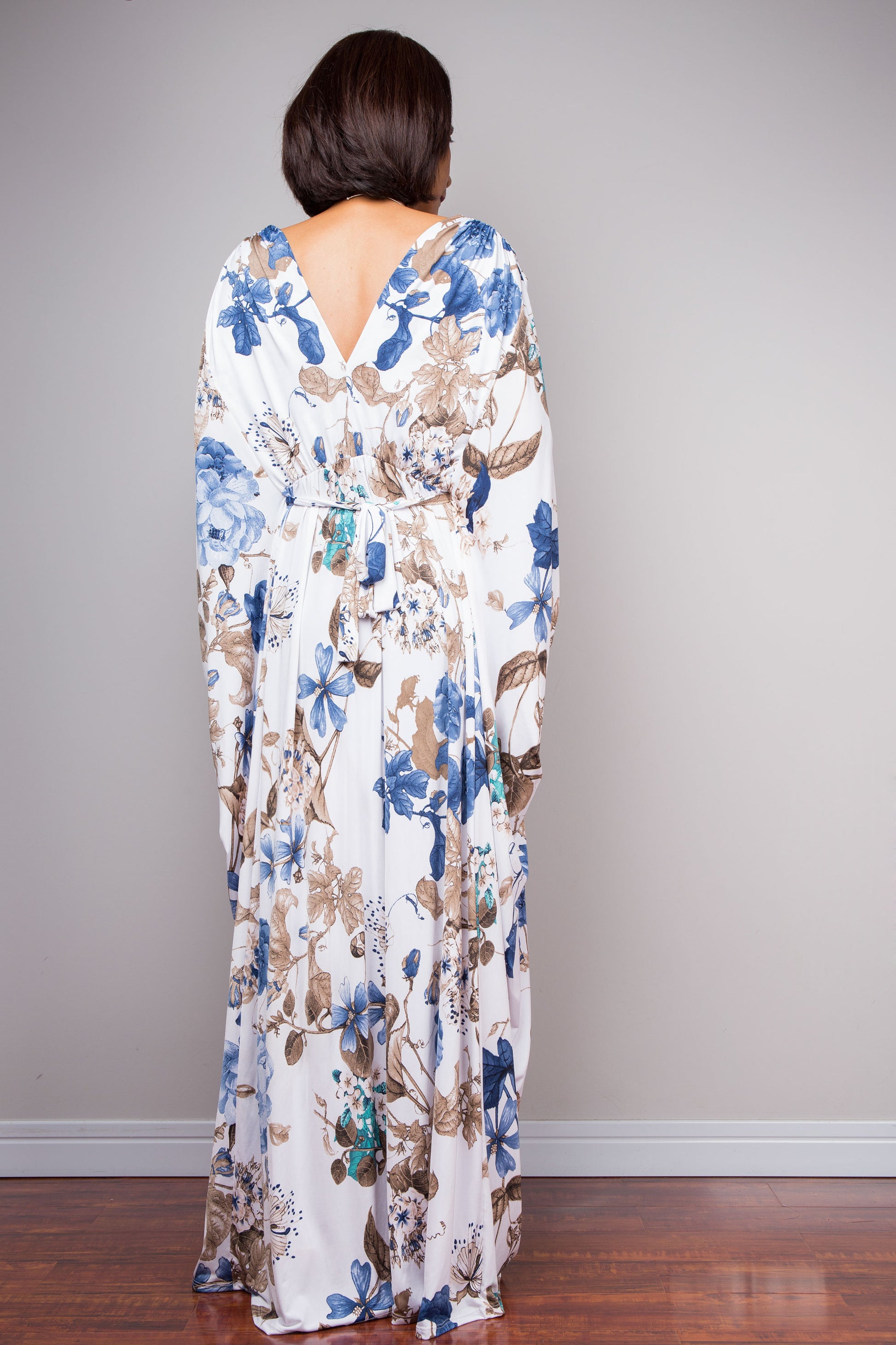 Full-length white maxi dress with blue and brown botanical design.
