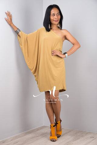 A sexy mustard yellow off shoulder dress for women. Short one shoulder knee length evening cocktail statement dress