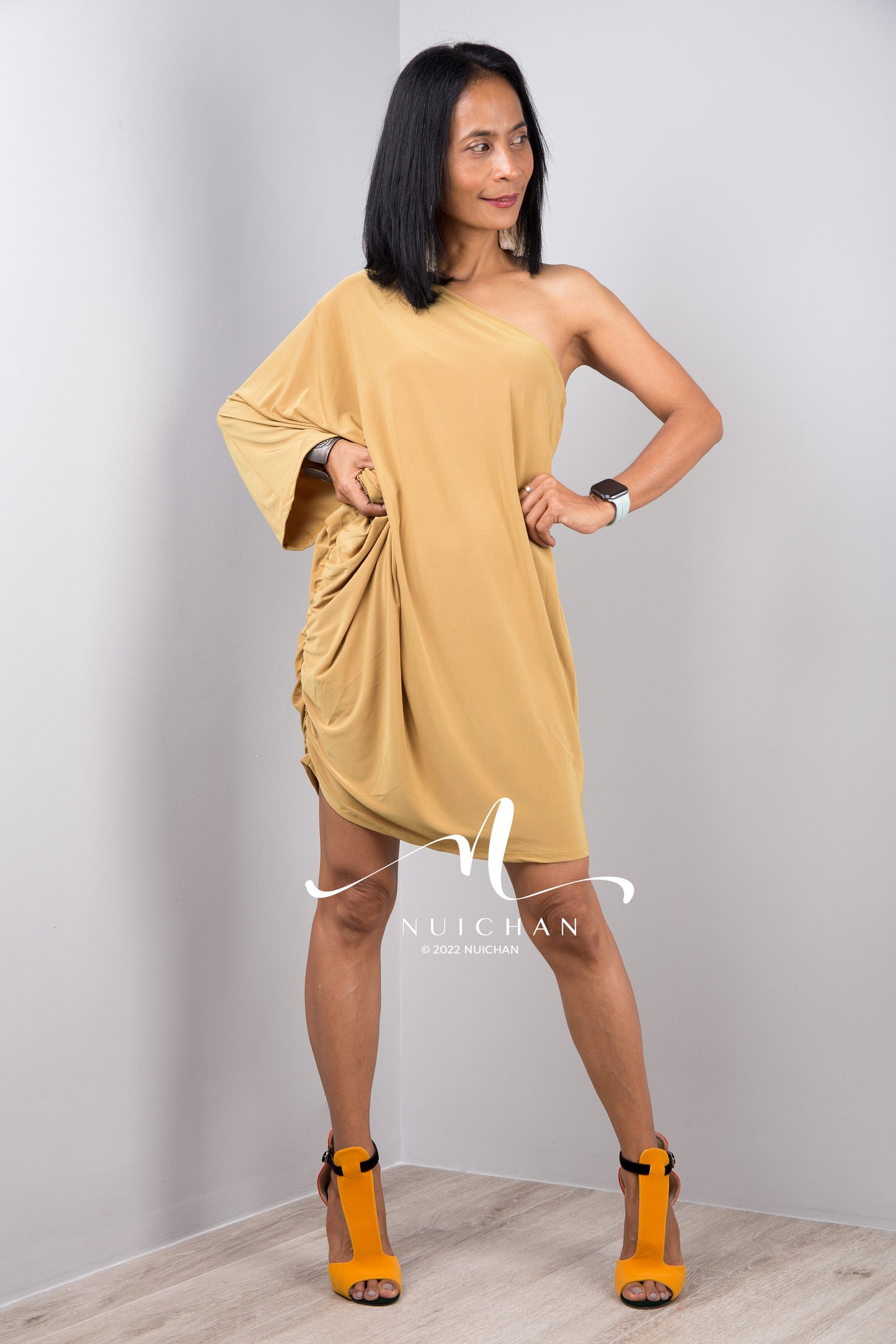 A sexy mustard yellow off shoulder dress for women. Short one shoulder knee length evening cocktail statement dress