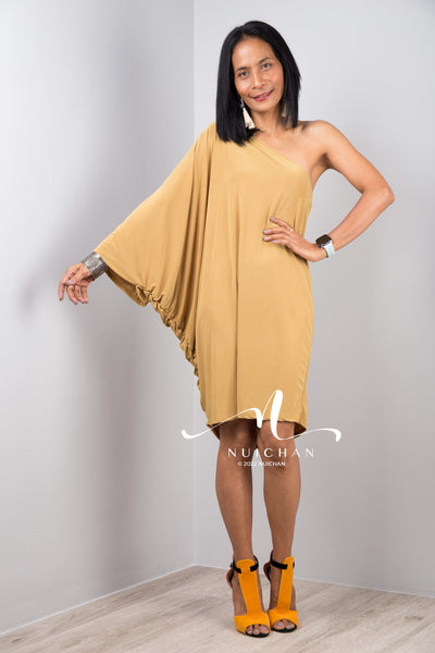 A sexy mustard yellow off shoulder dress for women. Short one shoulder knee length evening cocktail statement dress