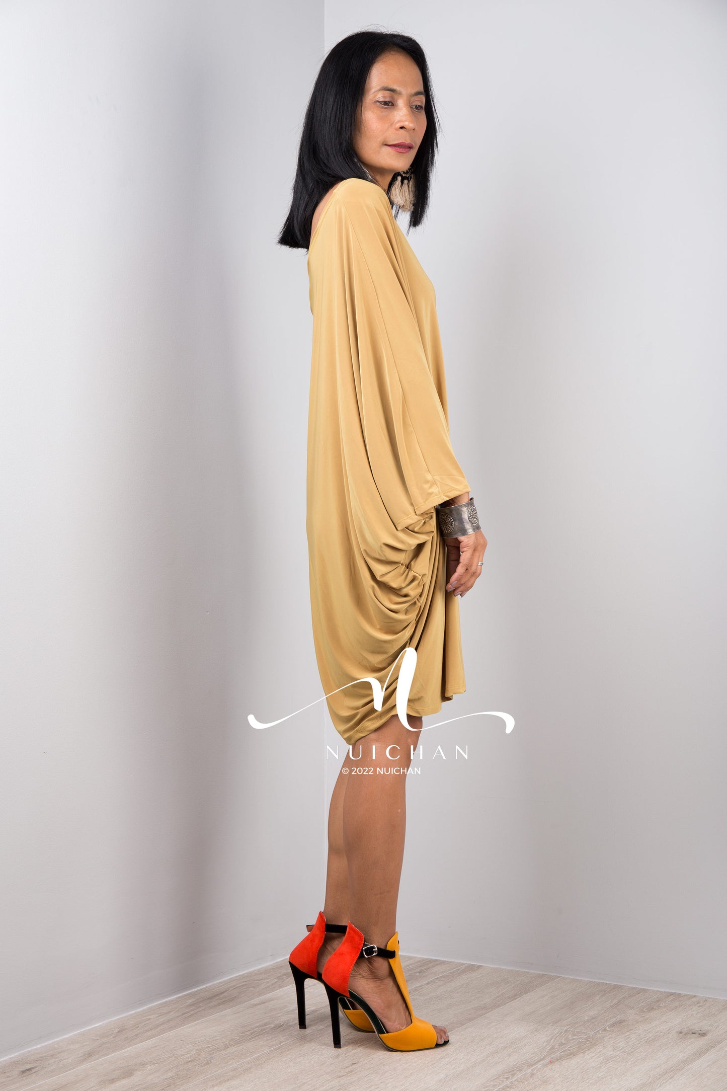 A sexy mustard yellow off shoulder dress for women. Short one shoulder knee length evening cocktail statement dress