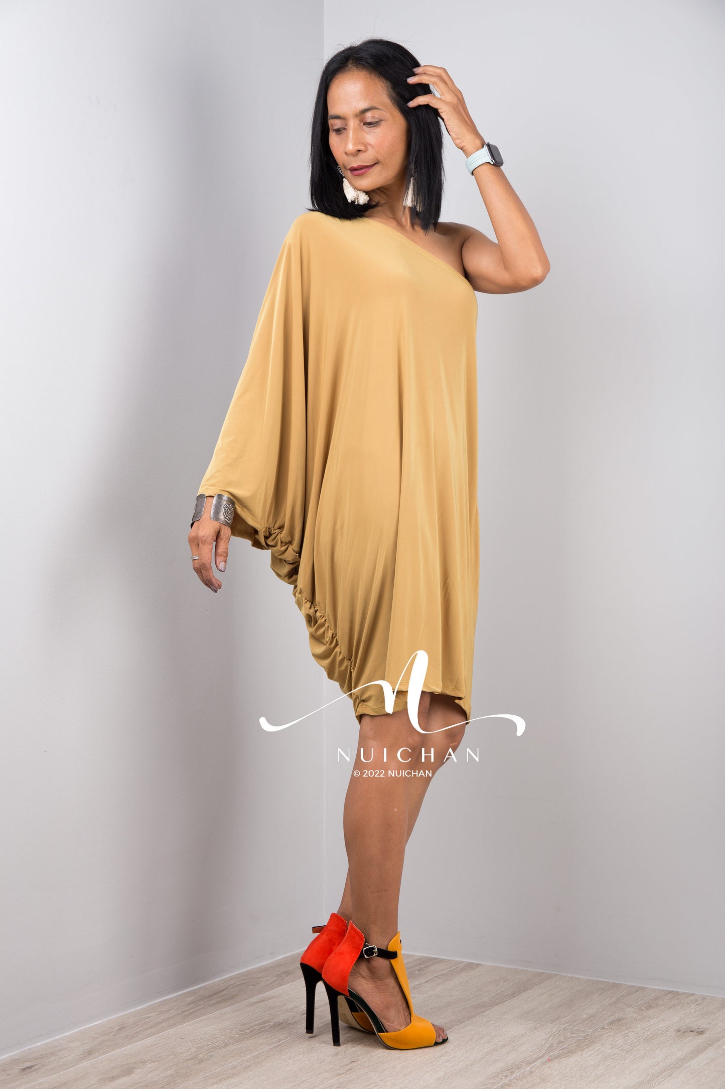 A sexy mustard yellow off shoulder dress for women. Short one shoulder knee length evening cocktail statement dress