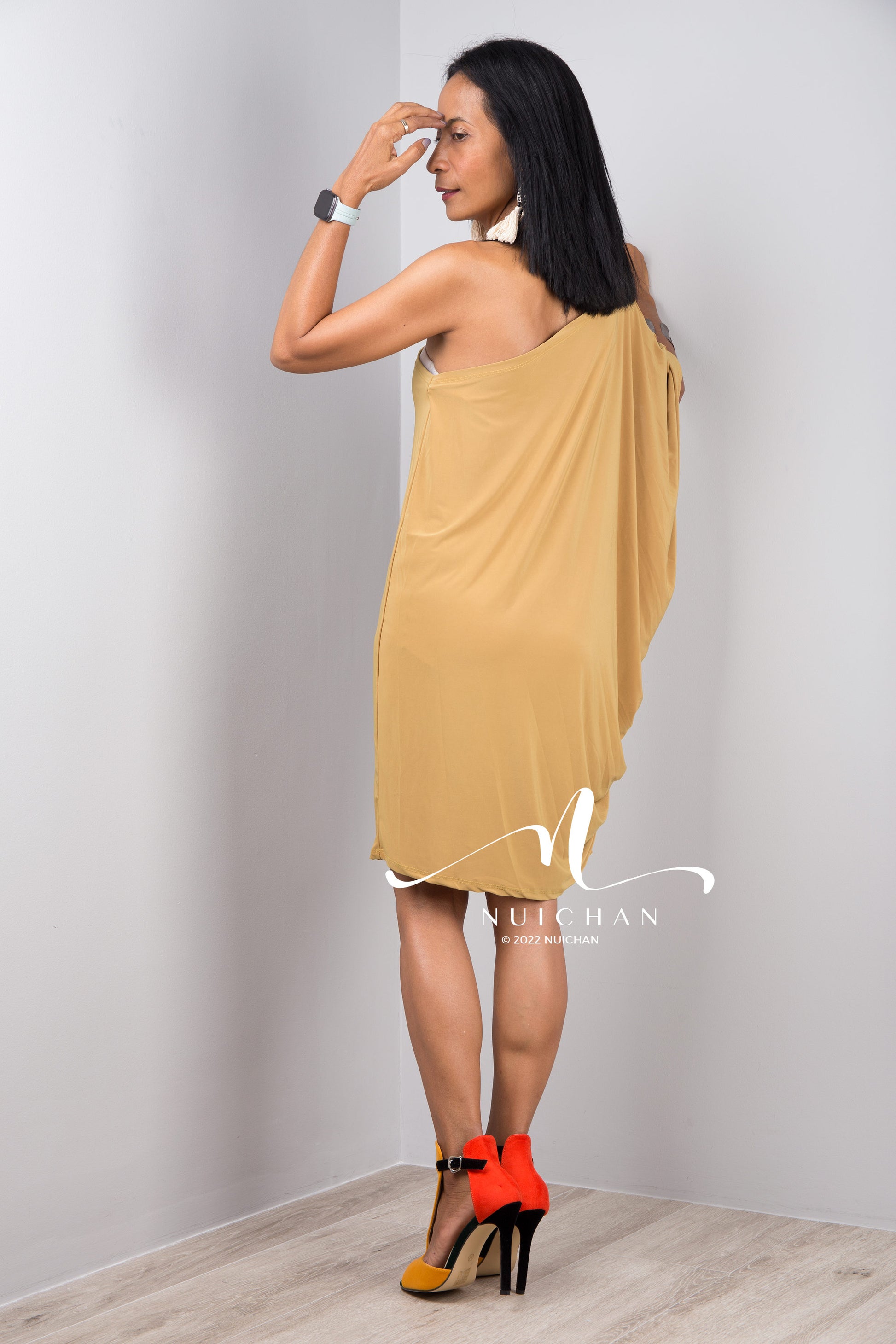 A sexy mustard yellow off shoulder dress for women. Short one shoulder knee length evening cocktail statement dress