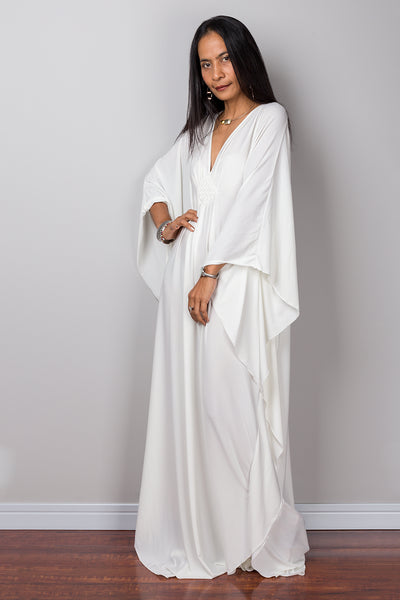 Buy plus size white kaftan online.  Shop for white maxi dress by Nuichan.  White frock dress with plunging neckline.