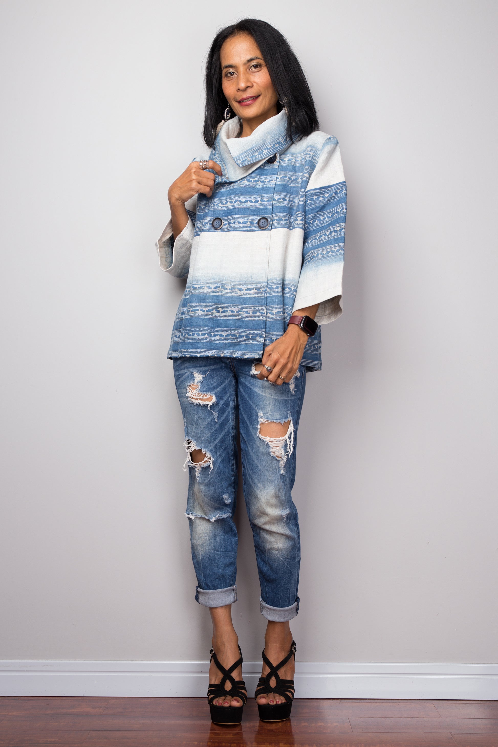 Styling shot of a woman wearing a hemp jacket blouse with slim-fit jeans and ankle boots, showcasing a casual boho-chic outfit.

