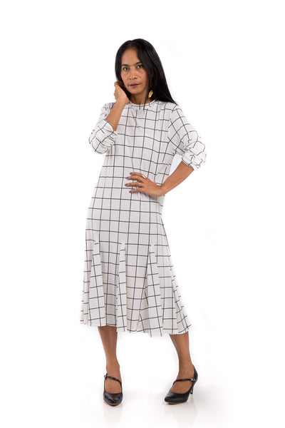 Knee length dress.  White dress with black square print.  Modest neckline and long sleeves.  Tube dress with pleated bottom part by Nuichan.