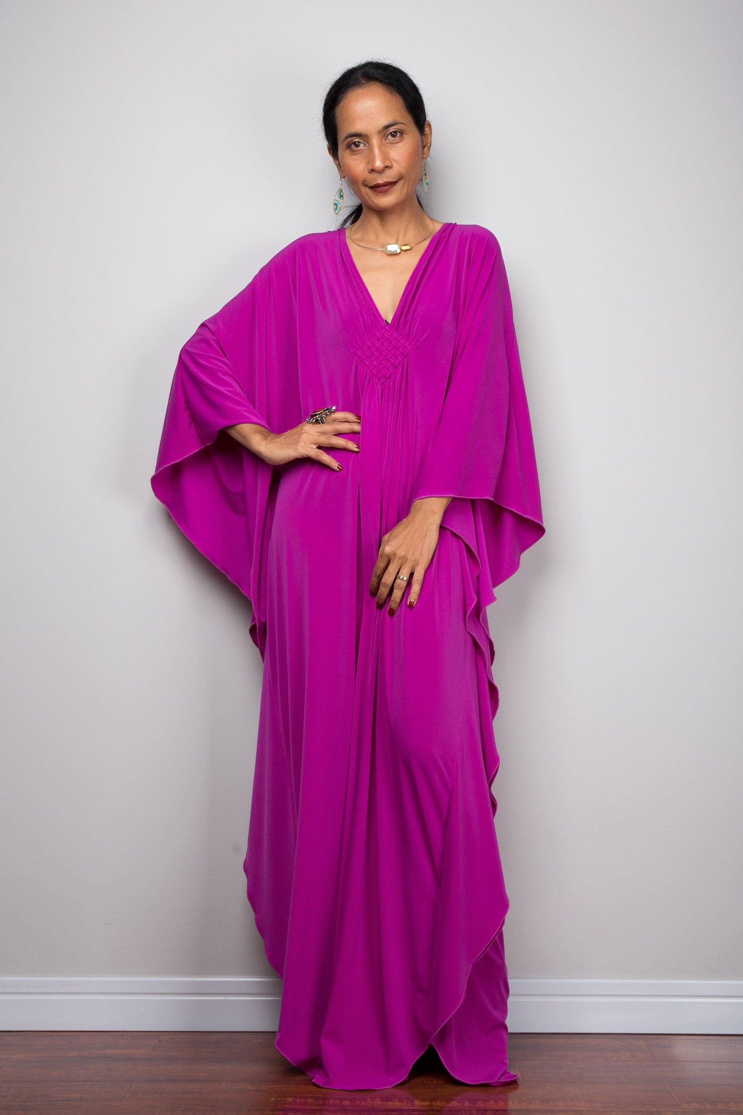 Shop for kaftan dresses online.  Magenta caftan dress by Nuichan.  A plus size purple kaftan dress with plunging neckline.