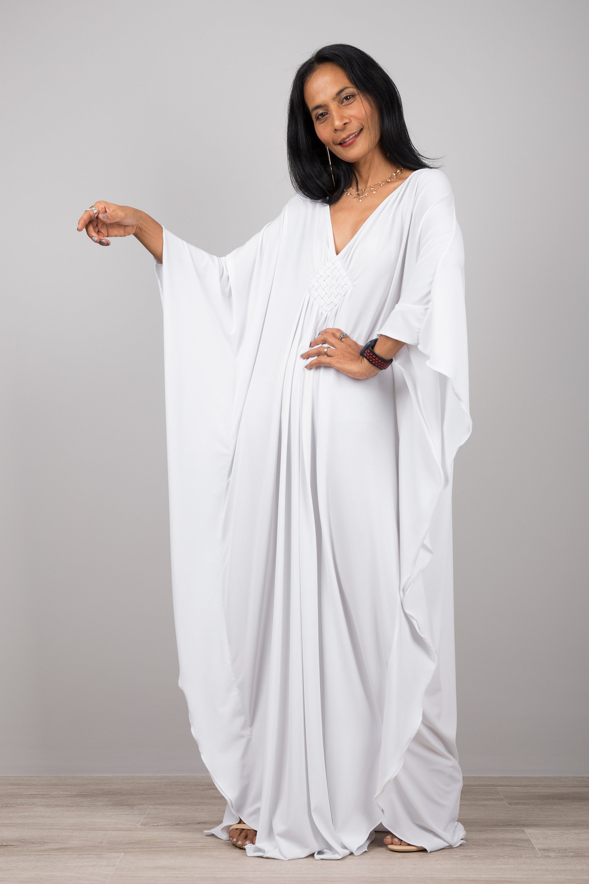 White kaftan dress with plunging neckline.  Buy your timeless kaftans online from Nuichan.  Express worldwide delivery via DHL.