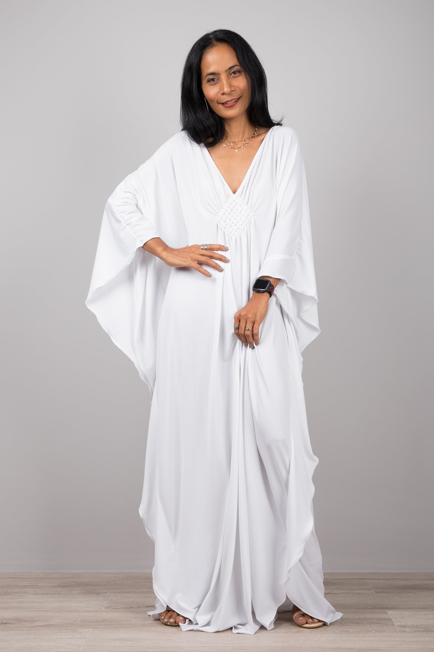 White kaftan dress with plunging neckline.  Buy your timeless kaftans online from Nuichan.  Express worldwide delivery via DHL.