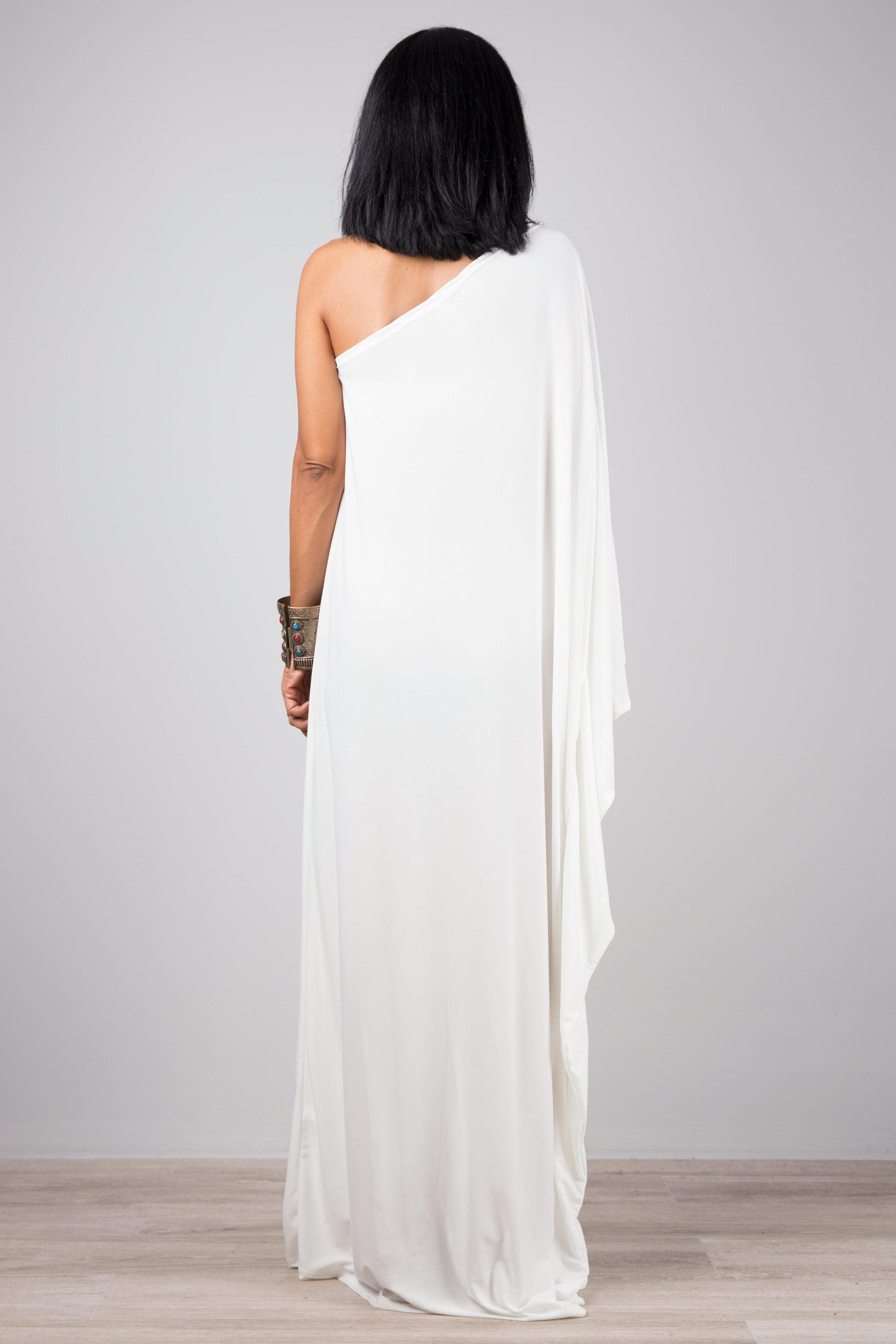 White evening dress with asymmetrical sleeve design.  One shoulder dress by Nuichan
